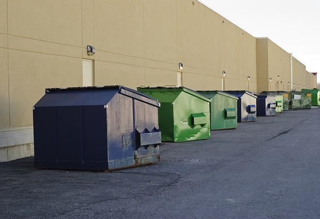 a fleet of red and blue construction dumpsters available for use in Splendora TX